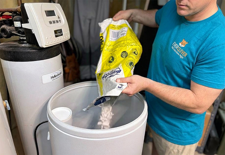 Ever Clever employee filling water softener tank.
