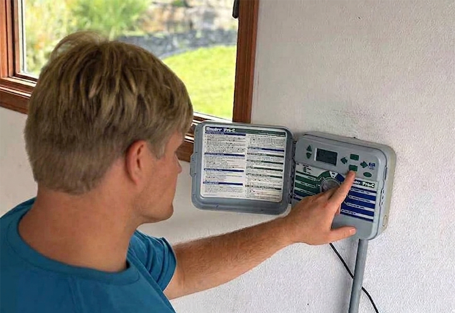 Ever Clever worker programming technology and setting irrigation systems.